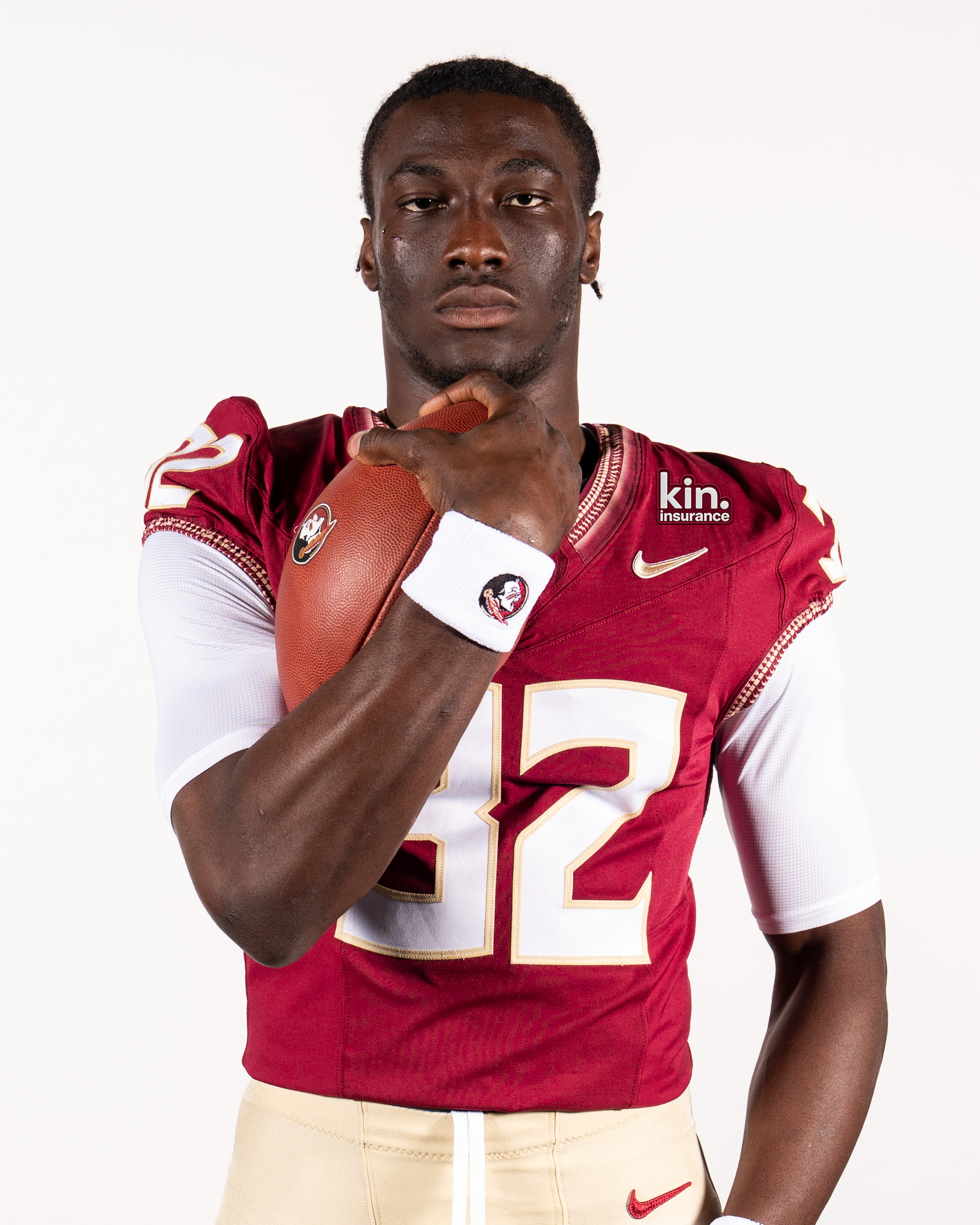 Florida State football player in a garnet jersey with the Kin insurance patch on the shoulder