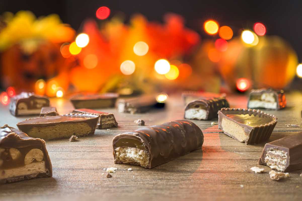 Pieces of chocolate candy bars with light bokeh in the background.