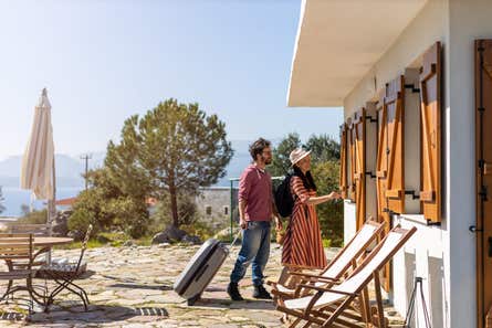 A couple on vacation unlocking the door to a beachside home