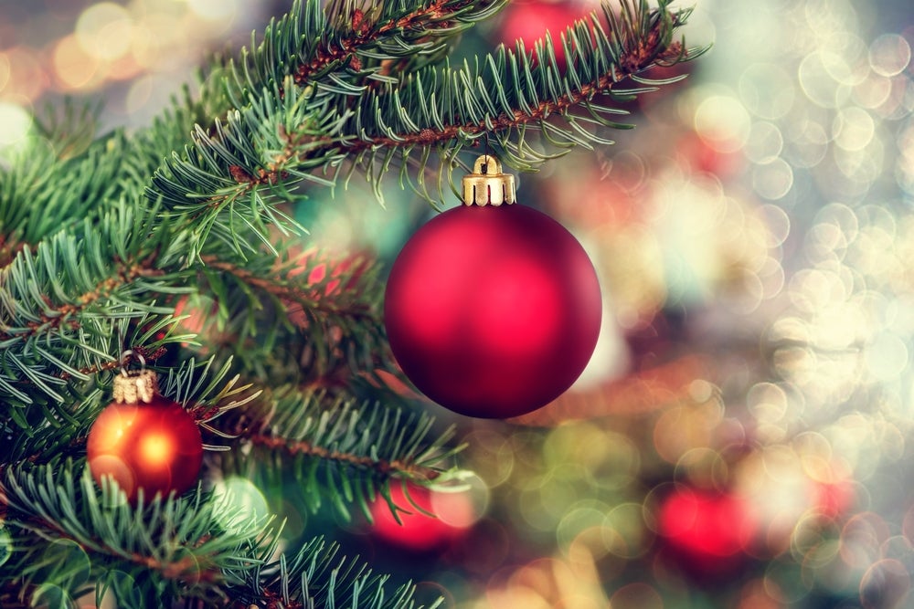 Close-up of a red Christmas ornament and lights on a Christmas tree