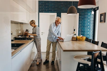 An older couple in a kitchen.