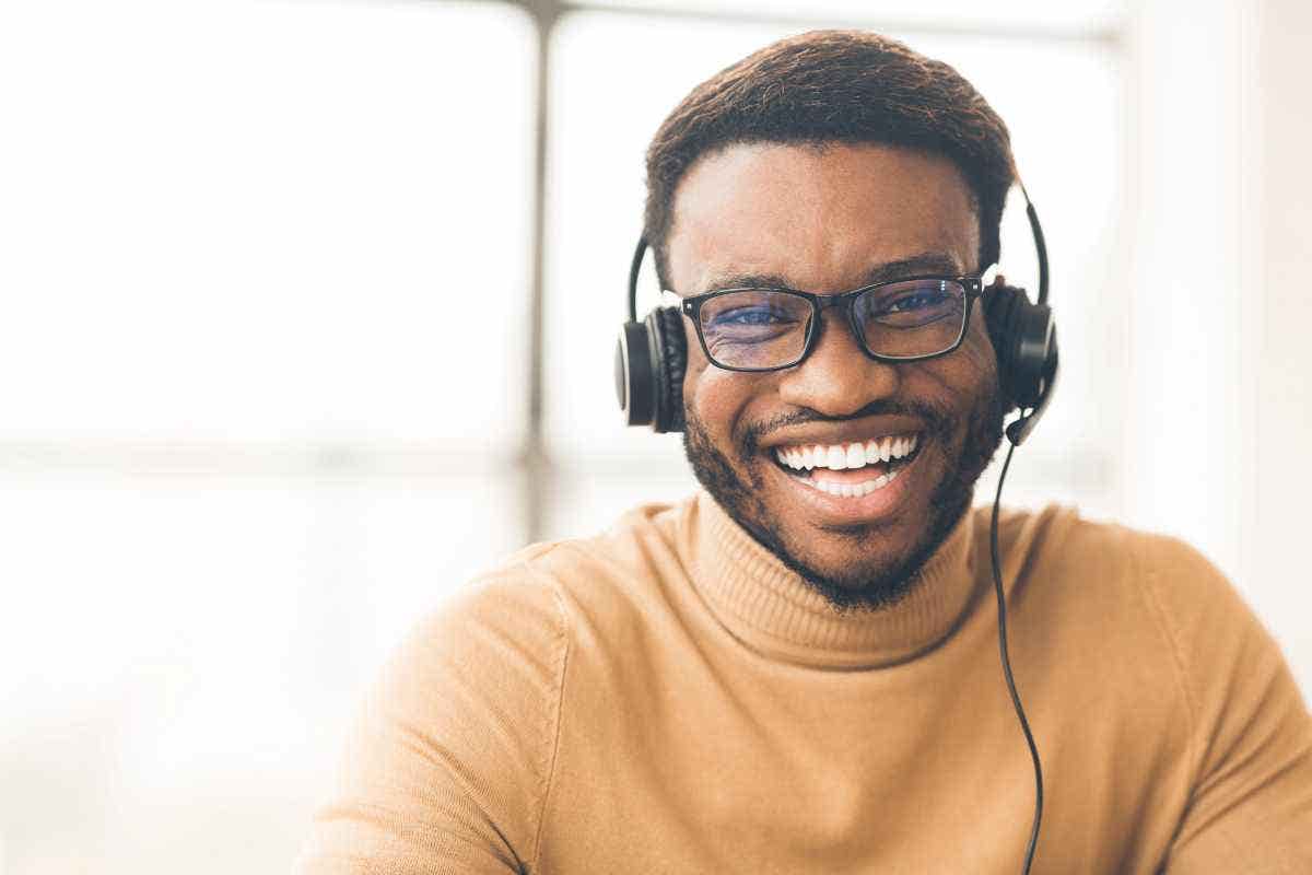 Smiling customer service rep with headset looking at camera 