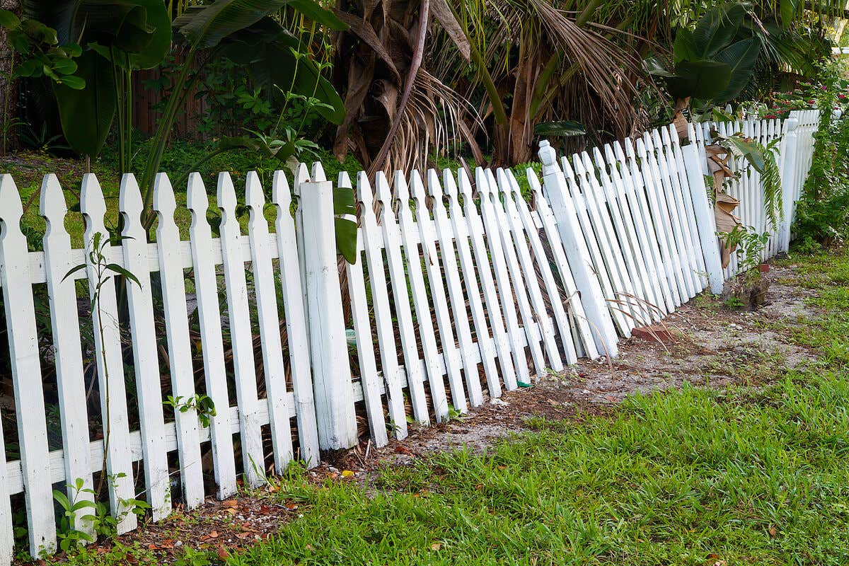 White picket fence in a state of disrepair