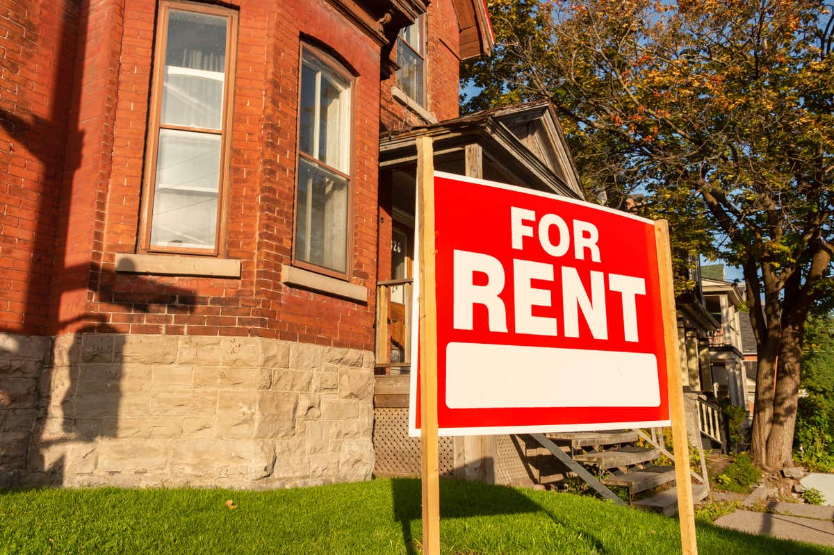A for rent sign in front of a duplex