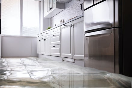 A close-up of a flooded kitchen floor