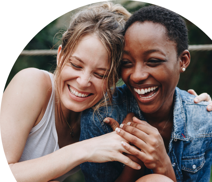 Two women hugging and laughing