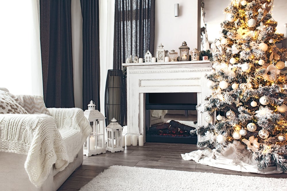 Picture of a white room with a fireplace, Christmas tree, and other Christmas decorations
