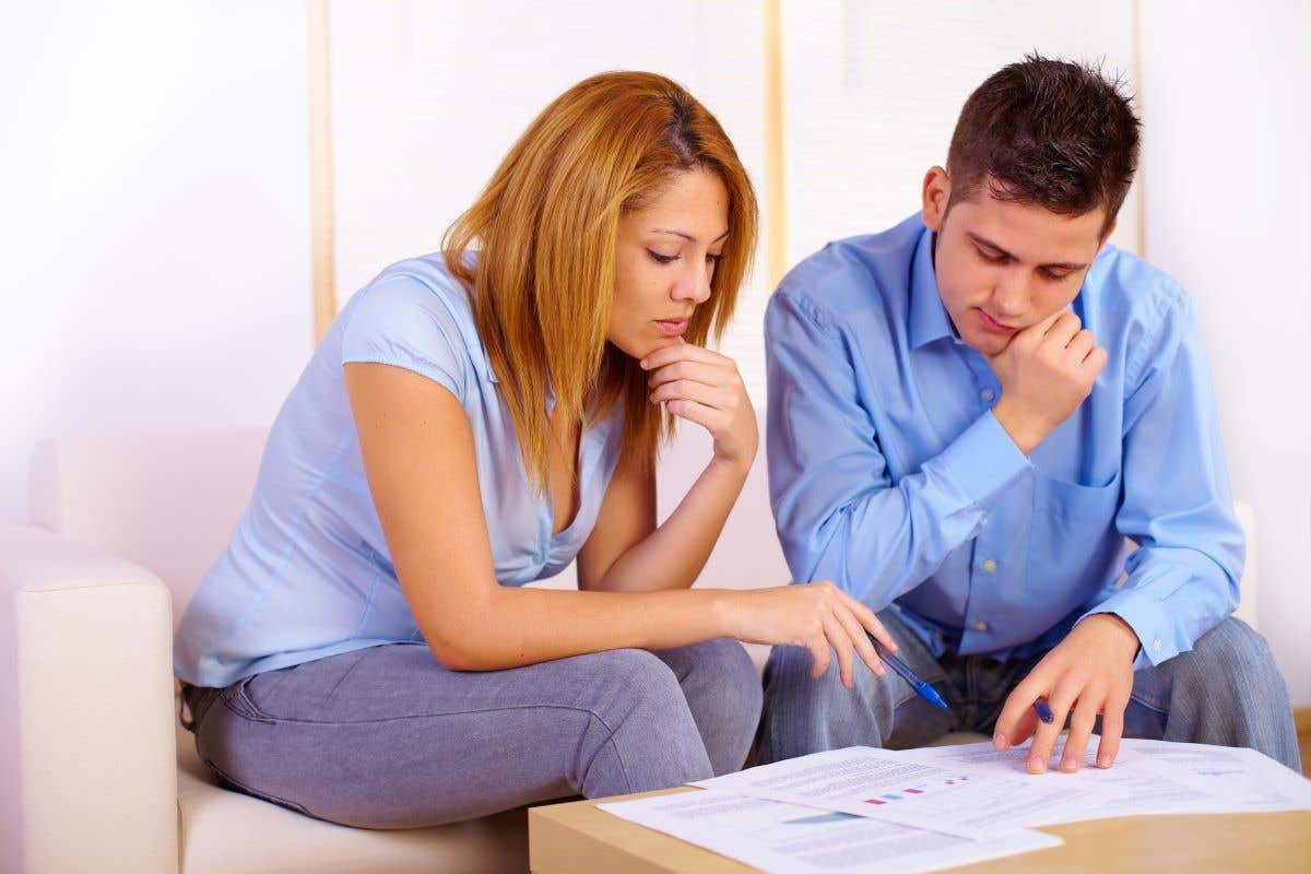 A young couple review their home insurance policy