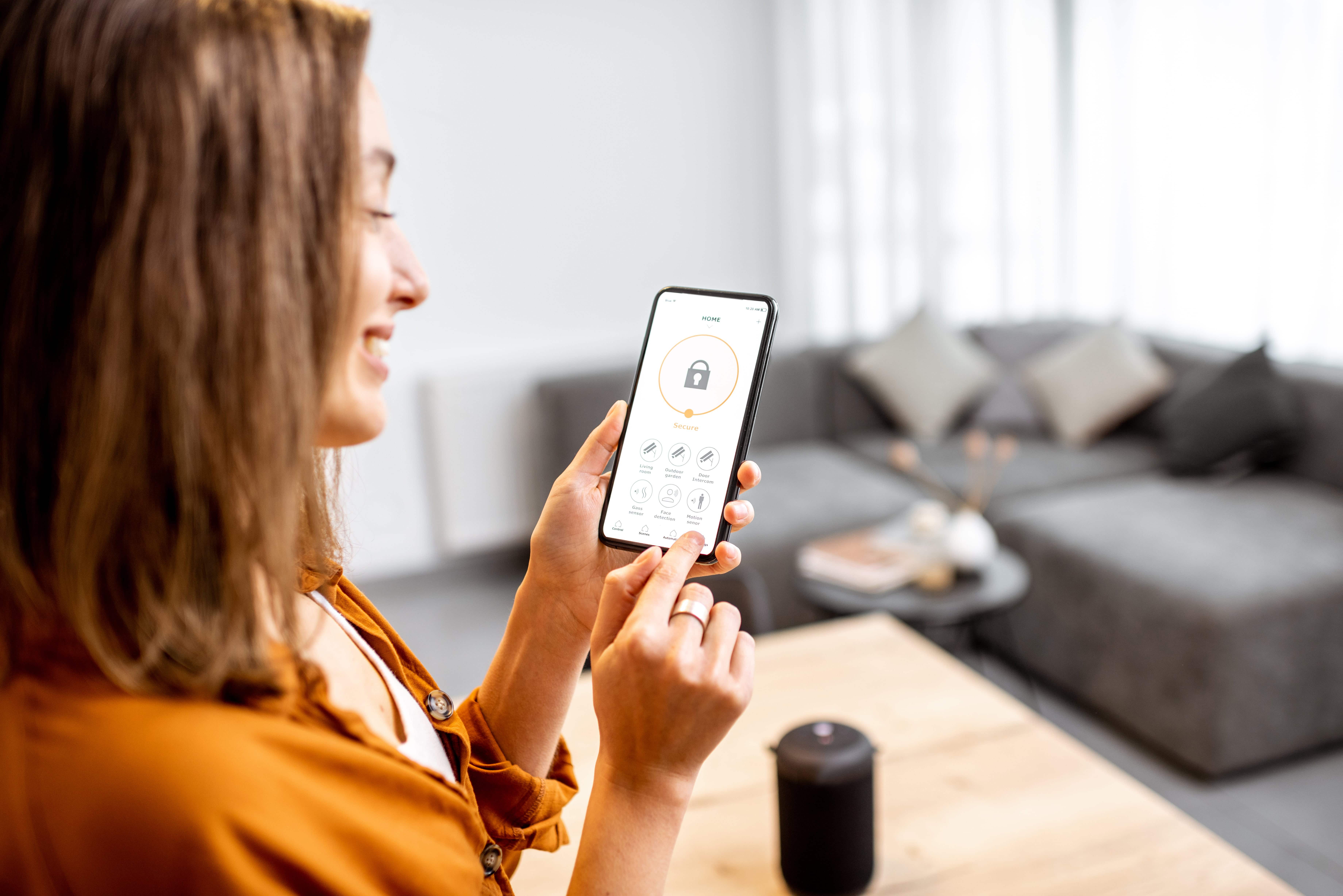 Woman using a home security app on her phone