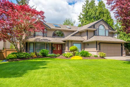 A two-story home with a large lawn