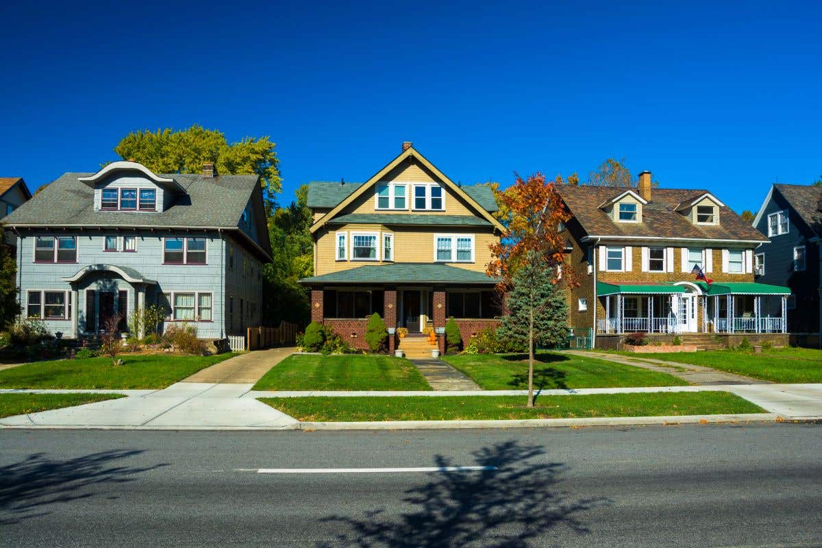 Three houses on a street in a residential neighborhood