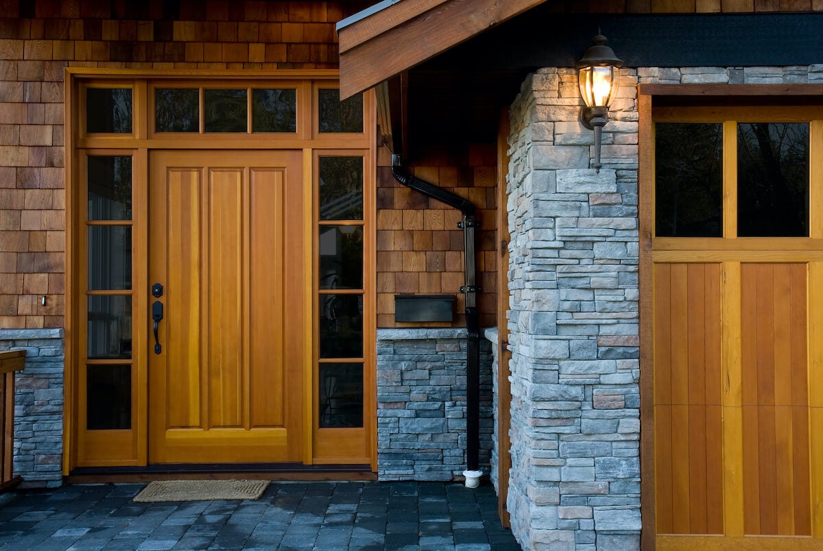 Closeup of the stonework and cedar siding on the entrance of a contempory home