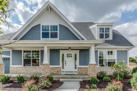 Exterior of a house with vinyl and brick veneer siding.