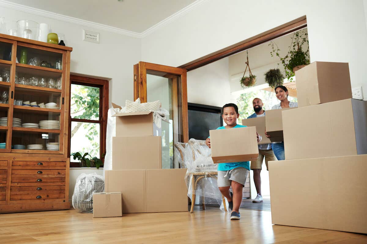 A family moving boxes into their new home