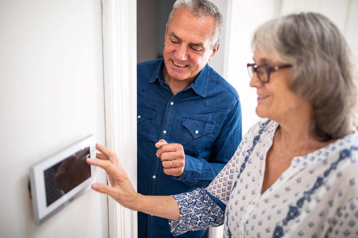 An elderly couple set their home's burglar alarm.