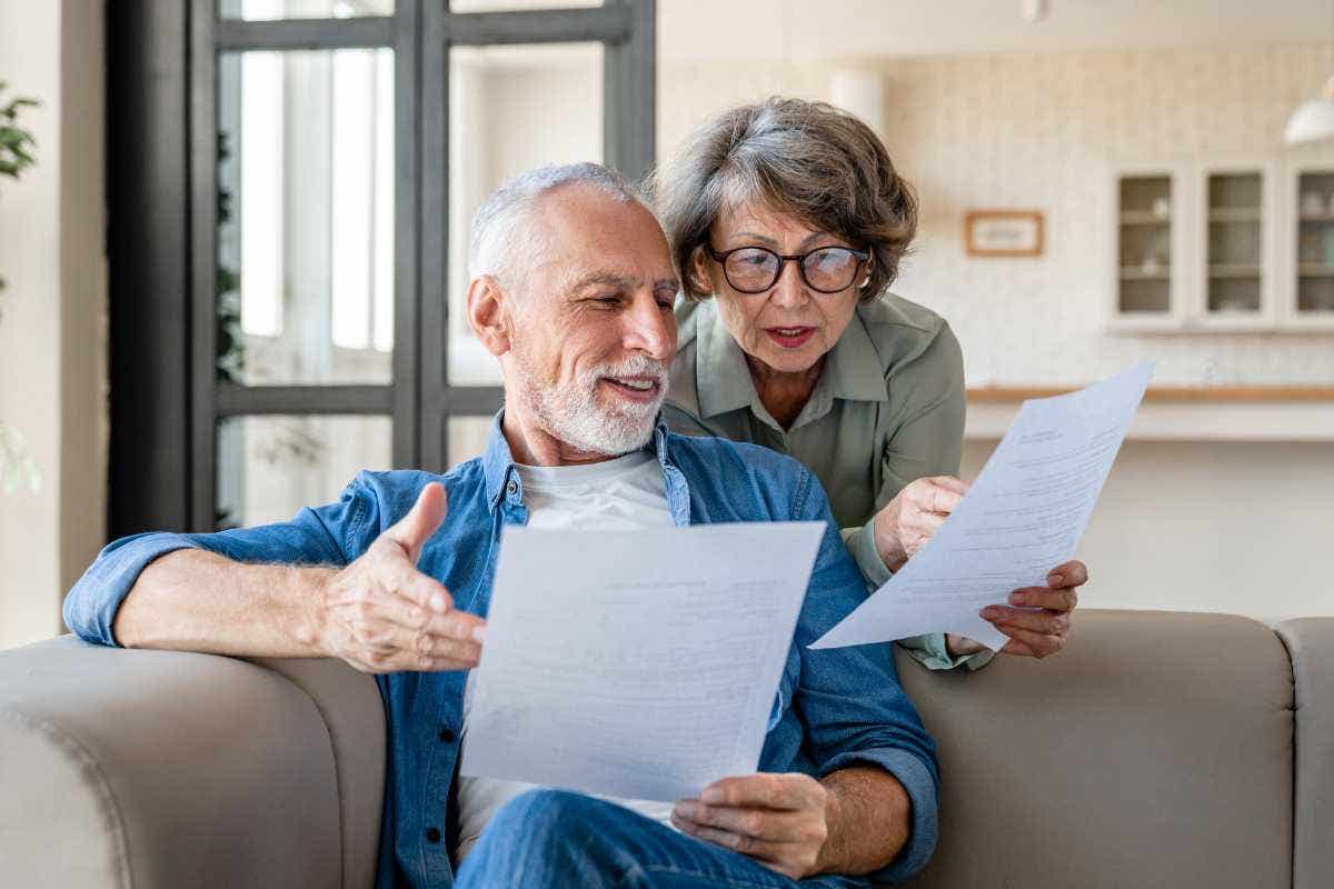 A senior couple reading their mortgage contract at home