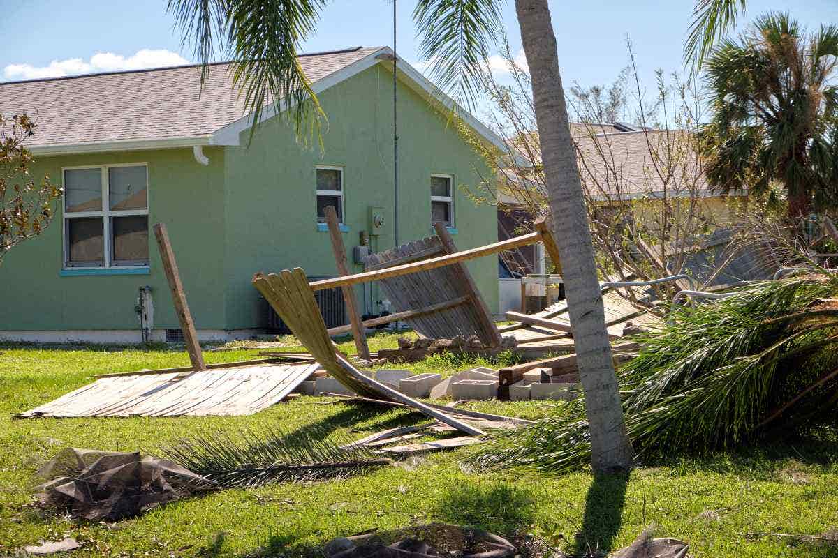 Home with debris scattered in the yard after a hurricane 