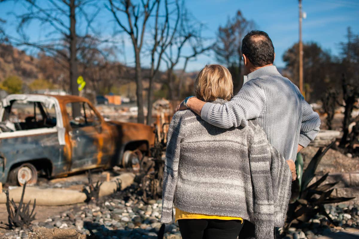 A couple returns to an area devastated by wildfire after a mandatory evacuation