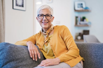 A vibrant elderly woman on a couch