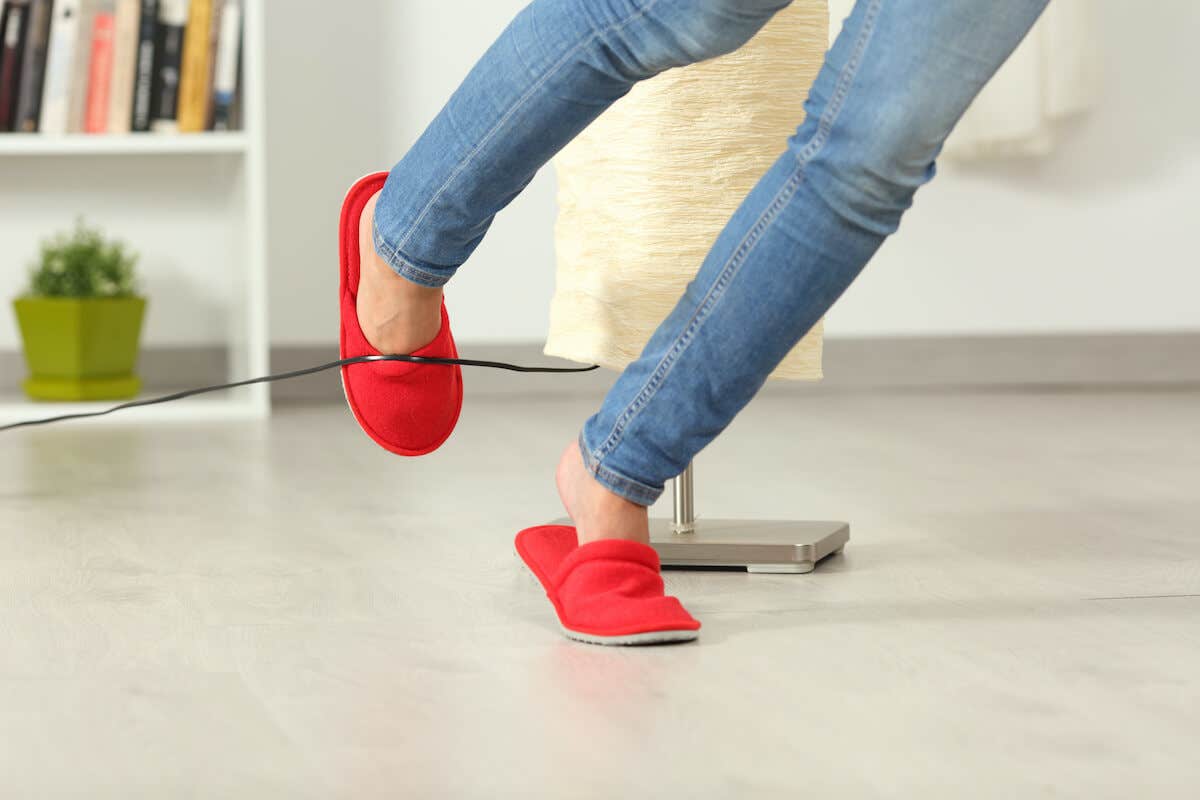 A woman's feet as she's tripping on an electrical cord
