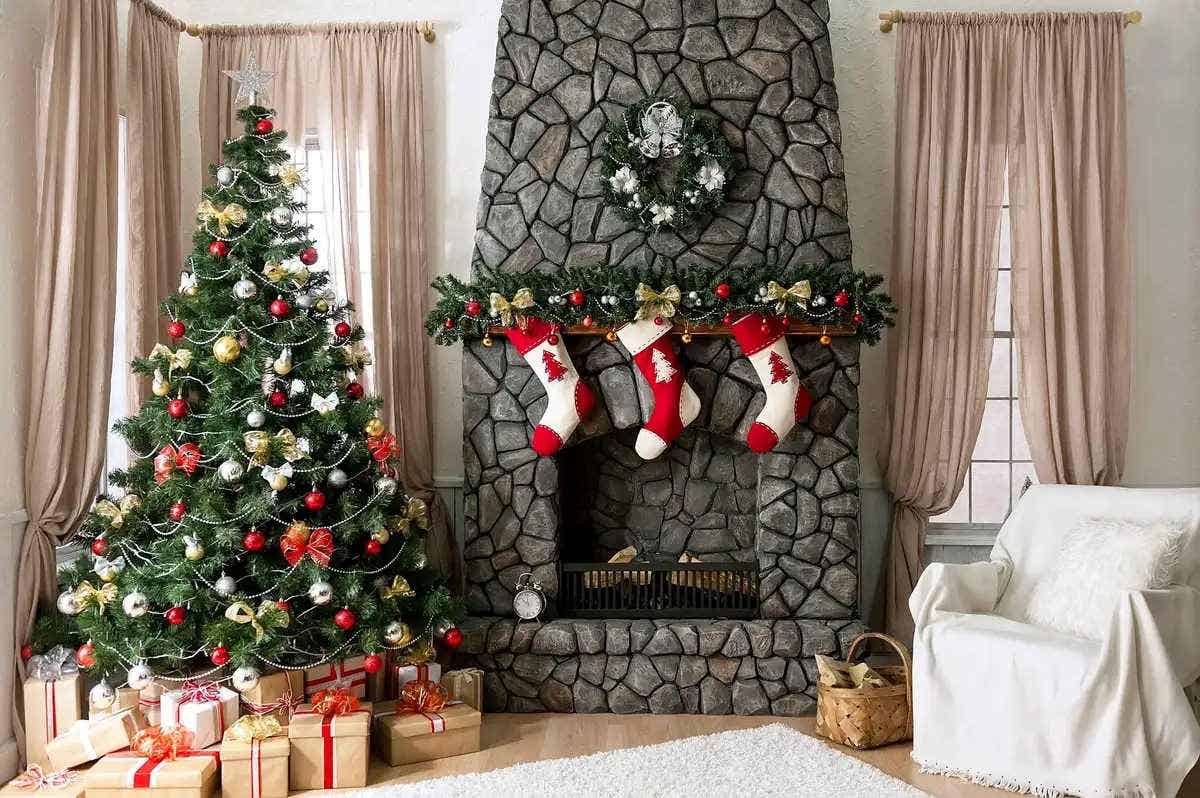 Decorated Christmas tree next to a stone fireplace