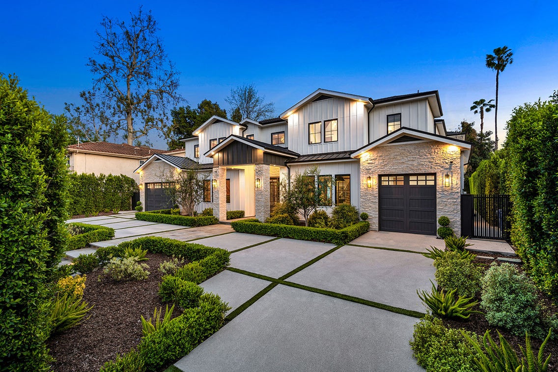 A modern two-story home with a landscaped front yard