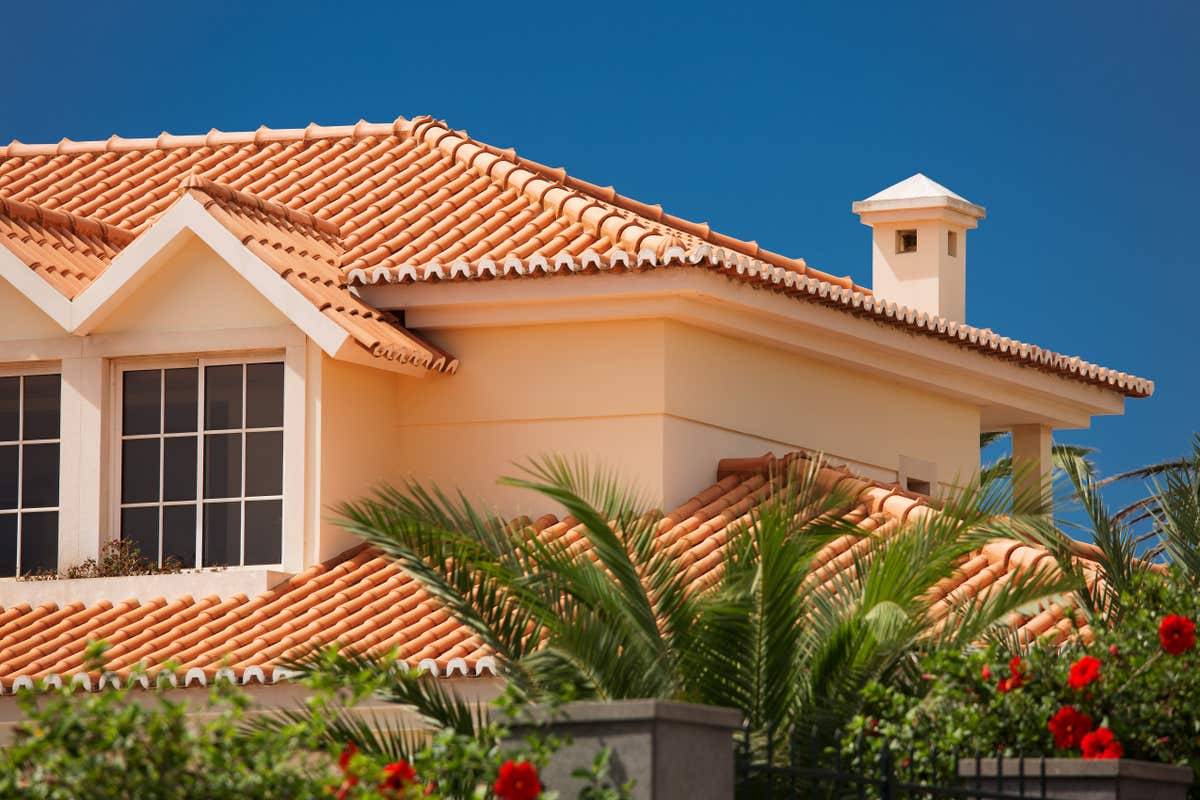 A Mediterranean-style home with a clay tile roof