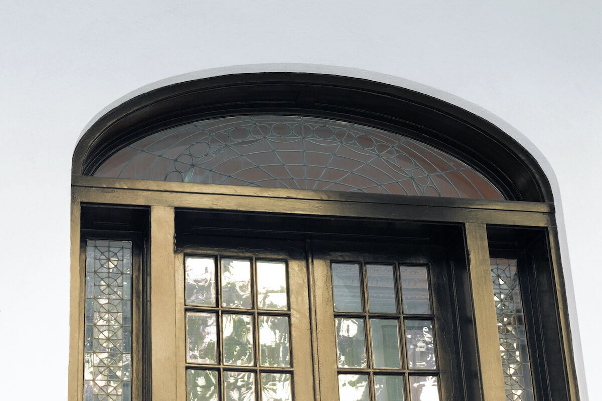 Traditional transom window with black ironwork