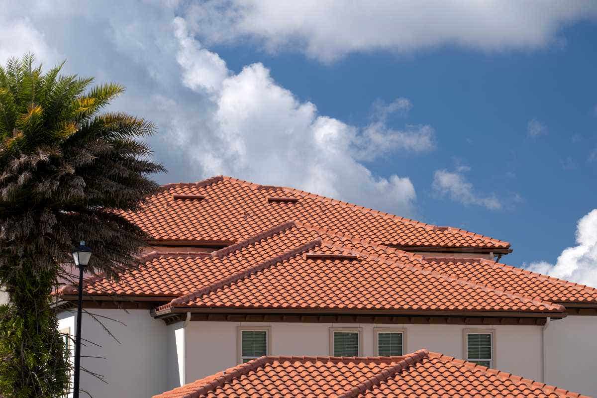 Closeup of house rooftop covered with ceramic shingles.