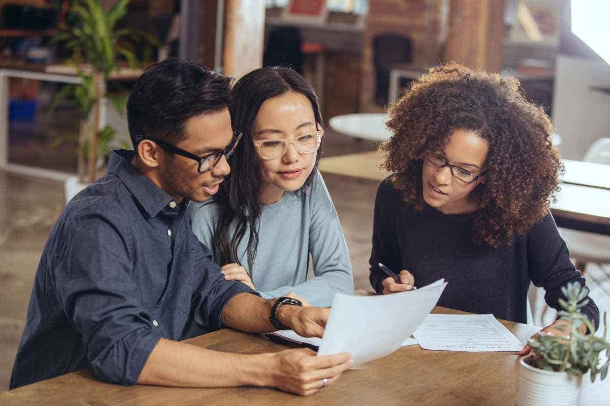 A young couple speaks to their insurance agent