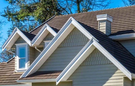 A multi-gable roof against a blue sky