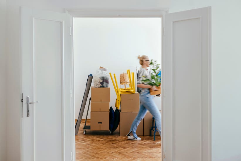 A student packing a box to move